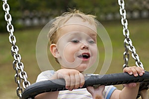 Boy smiling on swing