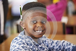 Boy smiling to camera in an elementary school lesson