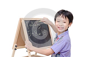Boy smiling between writing math answer