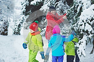 the boy in snow in the Park. A boy plays in winter Park. Adorable child walking in snow winter forest