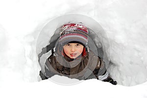 Boy in snow tunnel