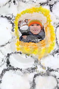 Boy with snowball in snow fortress