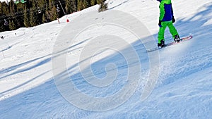 Boy on snowboard move fast ride downhill over