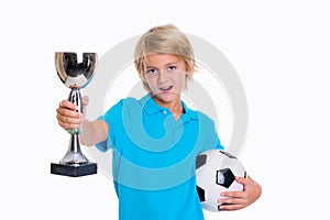 Boy with soccer ball and cup in front of white background