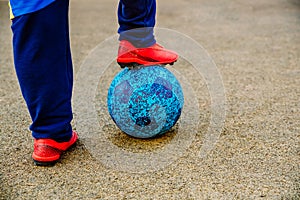 A boy with a soccer ball under his feet