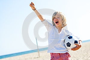 Boy with soccer ball and winning attitude.
