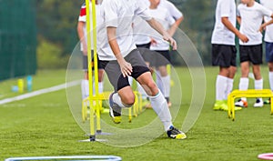 Boy Soccer Player In Training. Boy Running Between Cones During Practice in Field photo