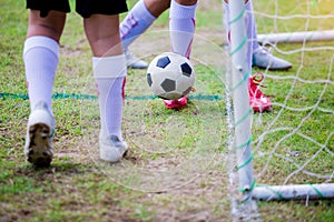 Boy soccer players trap and control the ball for shoot at front