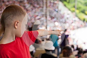 Boy among the spectators at representation