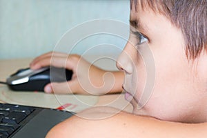 boy in spite of fatigue plays on the computer