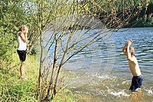 Boy splashing a girl