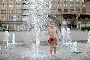 Boy and a splashing water fountain