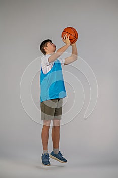 A boy in sporstwear with ball in hands