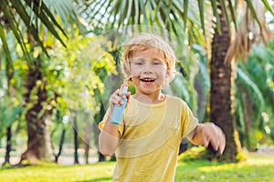 Boy spraying insect repellents on skin