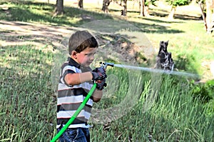 Boy spraying water in spring