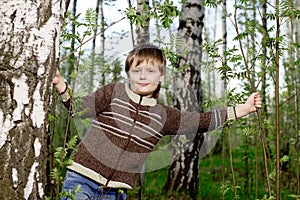Boy in spring birch forest