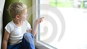 Boy staing inside house