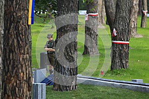 Boy stand near tombstones of Poles, victims of repressions at Polish military cemetery in Bykivnia near Kyiv. Ukraine