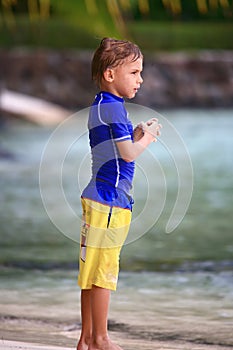 Boy standing on the beach