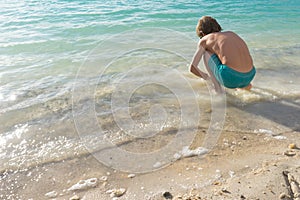 Boy standing on the beach