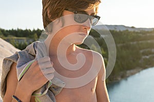 Boy standing on the beach looks into the distance