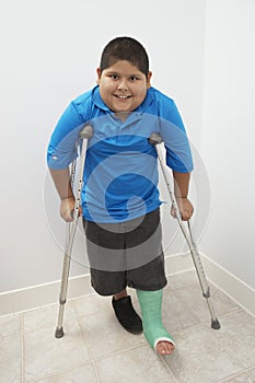 Boy Standing With Crutches