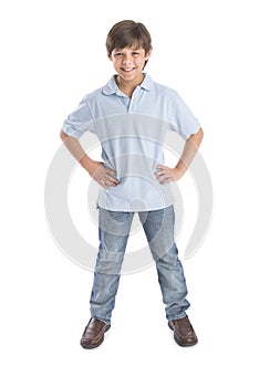 Boy Standing With Hands On Hip Against White Background