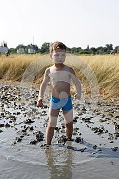 Boy standing in the healing mud