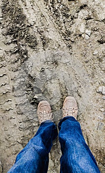 Boy standing on muddy field concept