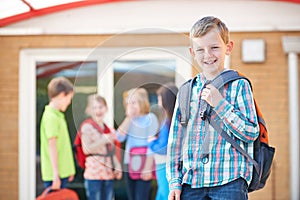 Boy Standing Outside School Classroom With Rucksack