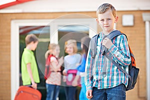 Boy Standing Outside School With Rucksack