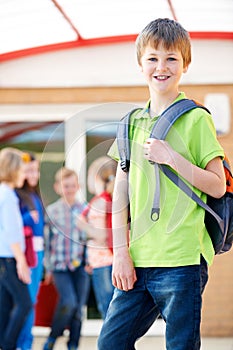 Boy Standing Outside School With Rucksack