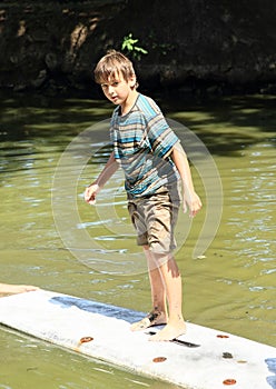 Boy standing on surf