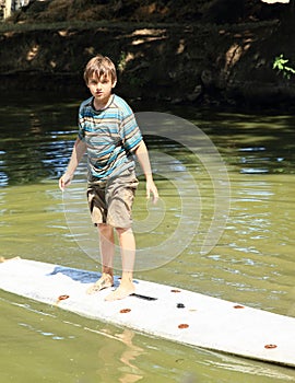 Boy standing on surf