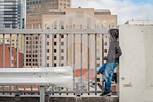 Boy standing on top of the roof