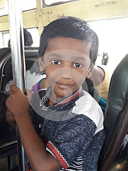 A boy  standing in travel bus