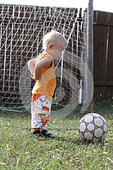 Boy stands in football goals