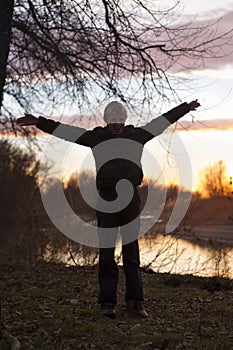 Boy stands in the sunset