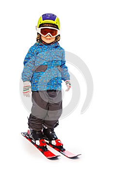 Boy stands wearing mountain skies isolate on white