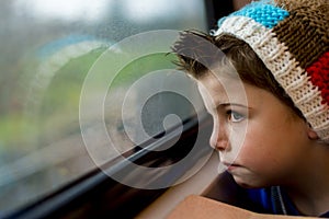 Boy staring through window