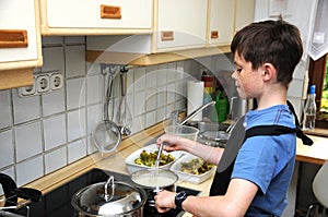 Boy stirring sauce