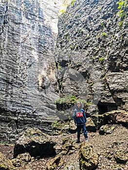 A boy in the Stone Bowl Gorge. A gorge in the mountains of the landscape nature of Dagestan. Russia.