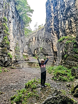 A boy in the Stone Bowl Gorge. A gorge in the mountains of the landscape nature of Dagestan. Russia.