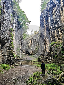 A boy in the Stone Bowl Gorge. A gorge in the mountains of the landscape nature of Dagestan. Russia.