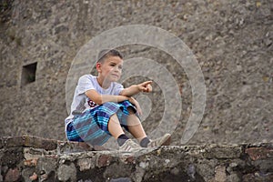The boy on the stone fence