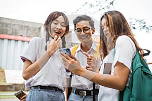 Boy student and girls are shocked when look smartphone screen