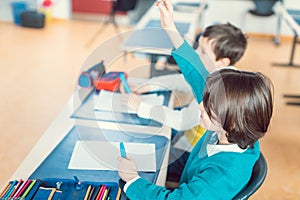 Boy student in school taking part in class answering a question