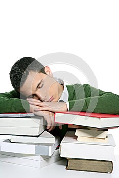 Boy student sleeping over stack books over desk