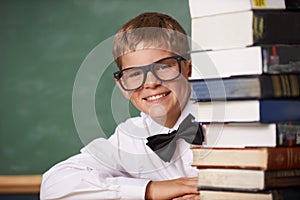 Boy student, smile and portrait with books, classroom and learning for exam, assessment and studying for knowledge