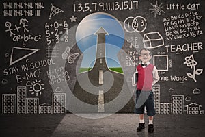 Boy student smiling in class with success road behind keyhole